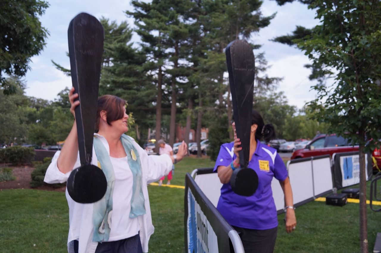 A Share the Fun representative and another woman poses with the exclamation points.